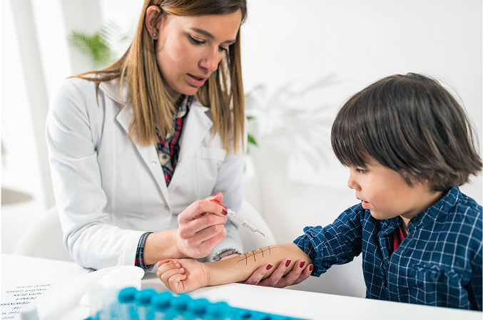 Child having an allergy finger prick test.